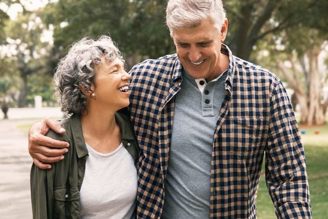 A couple: a man and woman smiling