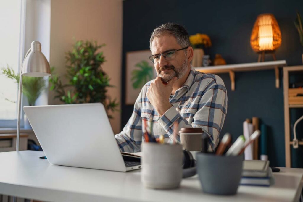 Man attending a webinar on his laptop